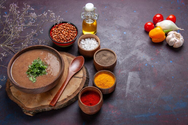 Spices chicken chickpeas and fresh herbs laid out in bowls for an appealing flat lay