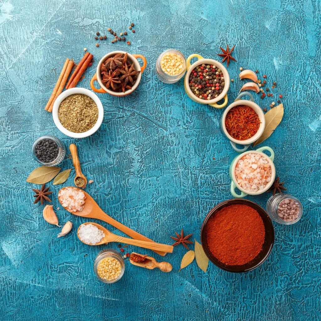 An aesthetically arranged flat lay of different spices in small bowls, highlighting their rich colors and textures.